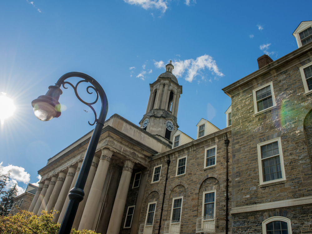 detail photo of Penn State Old Main building with sunny sky