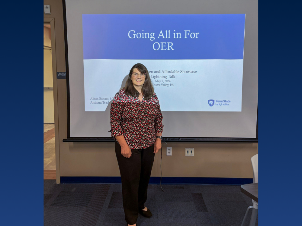 a female professor smiling in front of a classroom