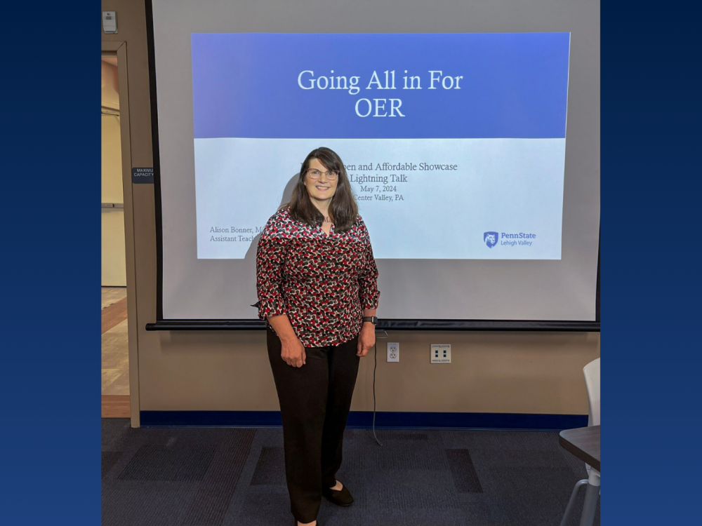 a female professor smiling in front of a classroom 