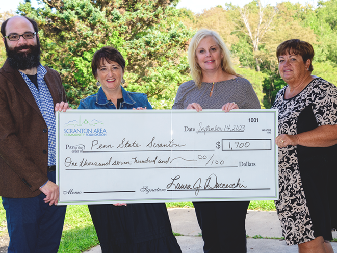 Scranton Foundation reps and Director of Development Chris Ostroski pose with grant check