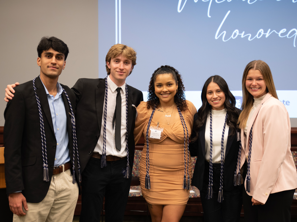 Five Tri-Alpha members pose, wearing their new cords