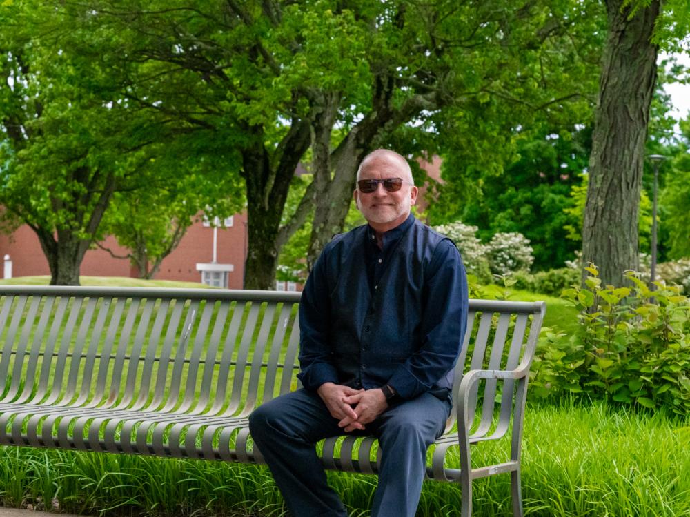 W. Charles Patrick sitting on campus.