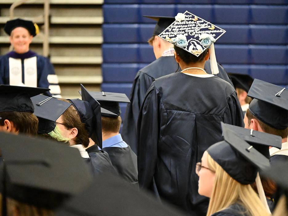 A close-up of graduates' caps as they walk to the stage.