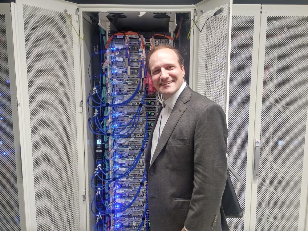 Eric Ford poses for a photo in front of clusters in the Penn State Data Center.