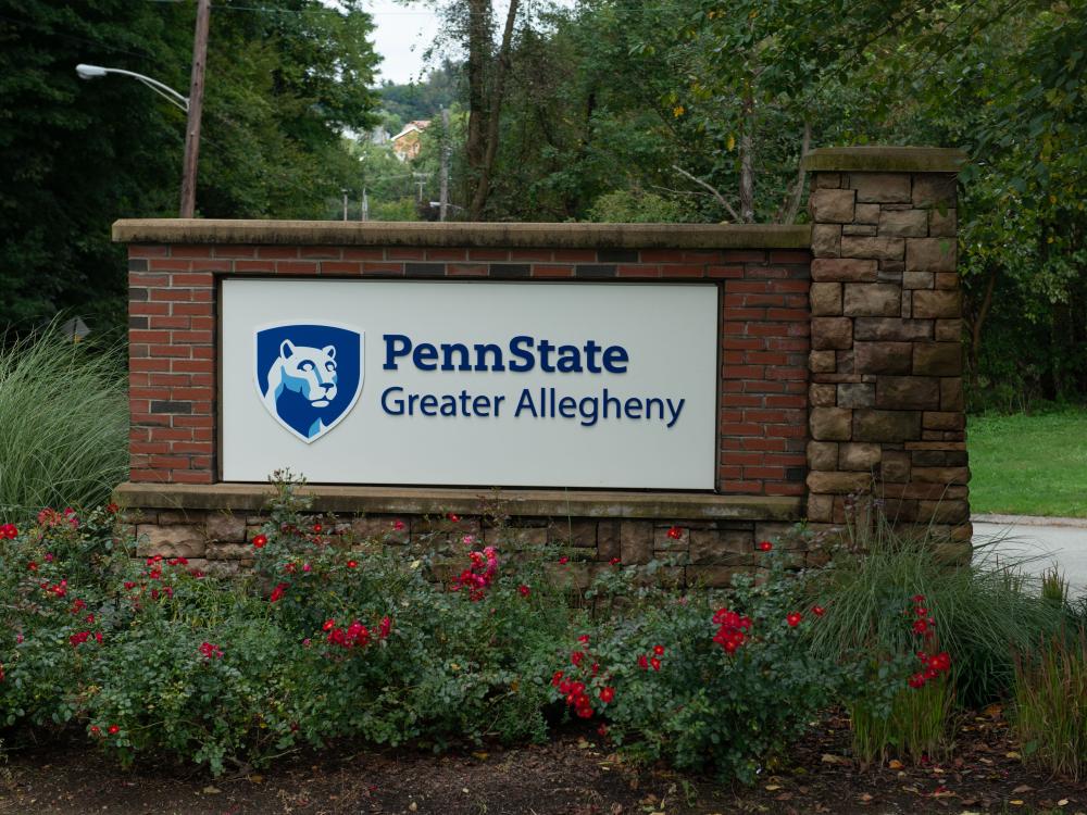 A Penn State Greater Allegheny sign is pictured surrounded by greenery.