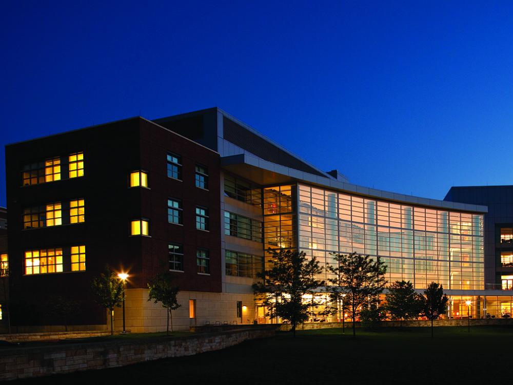 A night-time picture of the Business Building at Penn State.