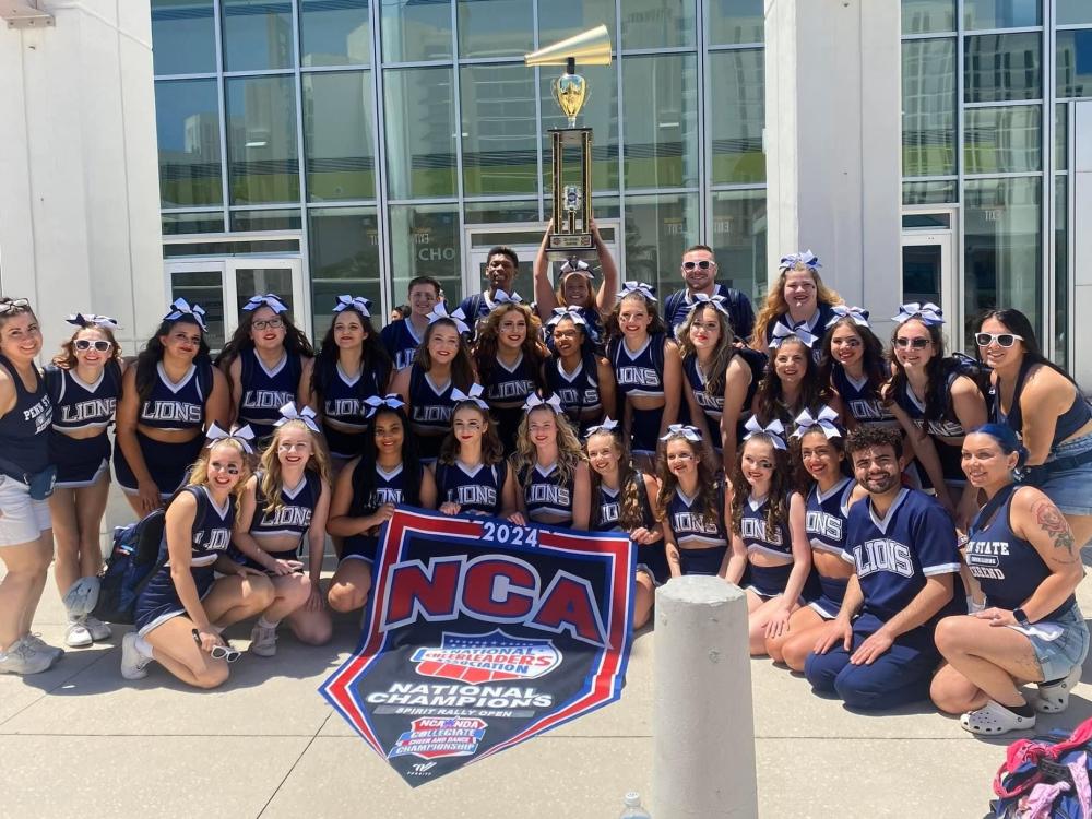 The Penn State Behrend cheer team poses with the trophy after winning the national title.