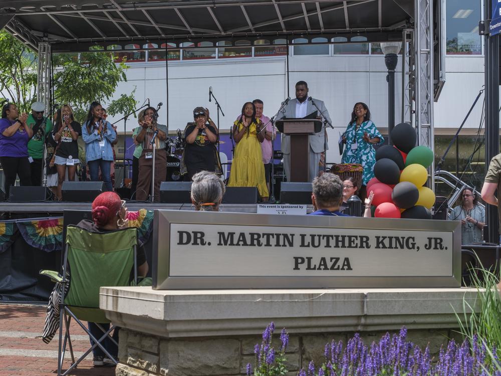A colorful stage with performers in the Martin Luther King Plaza