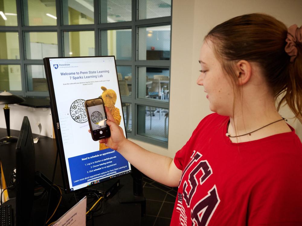 Penn State student scans Penn State Learning QR code with her smartphone.