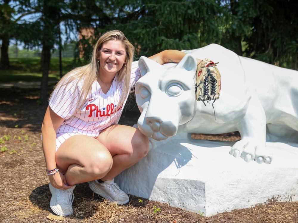 Farrell Everett in Phillies uniform with glove next to Nittany Lion