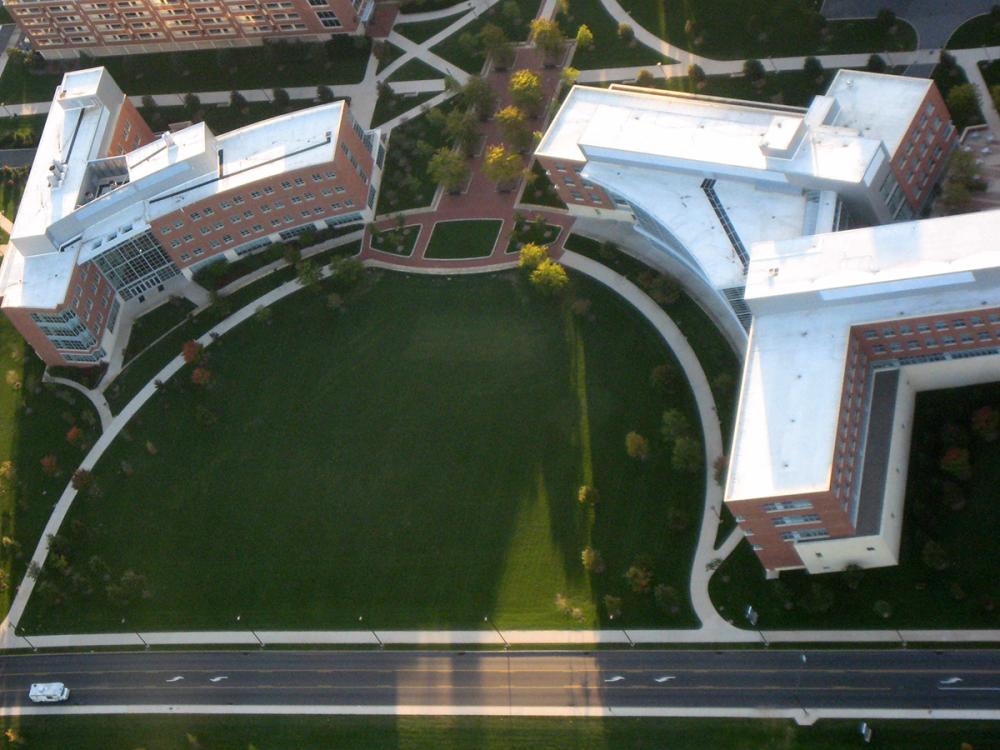 An aerial view of the Business Building, with the Forestry Building to the left and an open, grassy area in the middle.