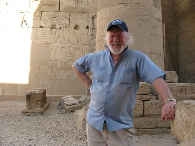 Don Redford stands against backdrop of anicent Egyptian site. 