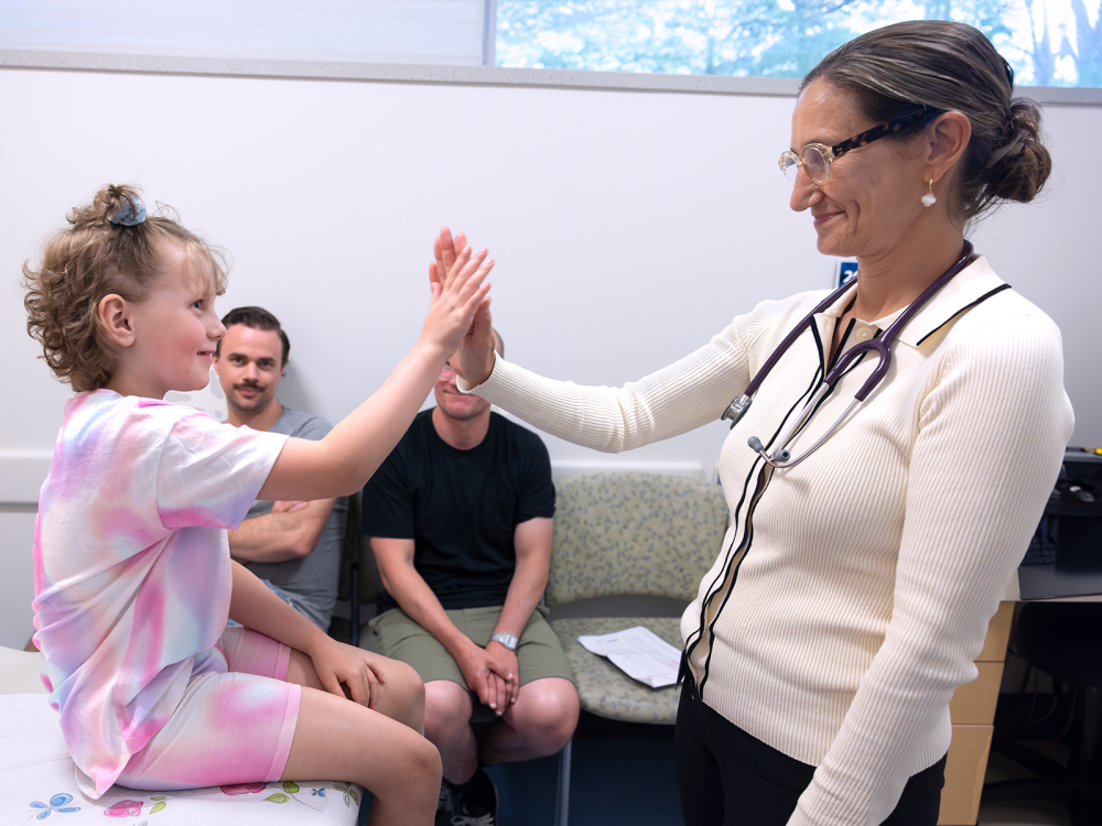 Doctor giving child patient a high-five