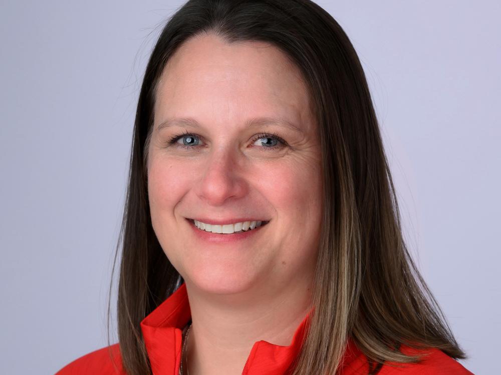 A headshot of a woman wearing a red Team USA jacket.