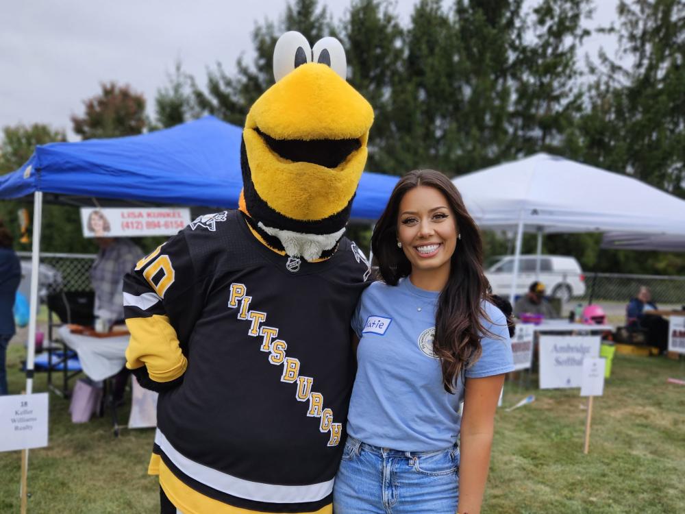 Penn State Extension Master Watershed Steward volunteer Katie Stanley poses with Pittsburgh Penguins mascot Iceburgh