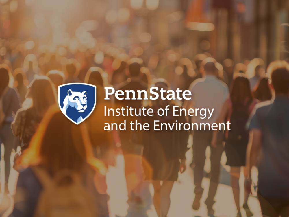 Penn State Institute of Energy and the Environment mark on a golden hour image of crowd of people walking