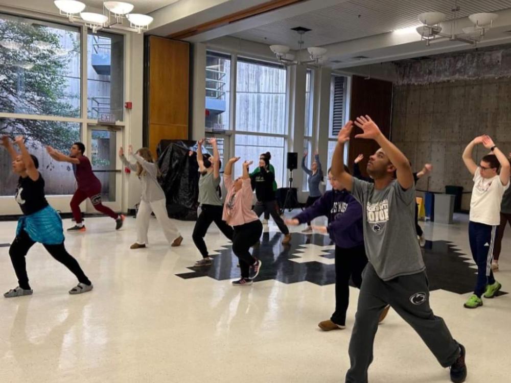 group of students participating in a group activity in a large room at Penn State University Park campus