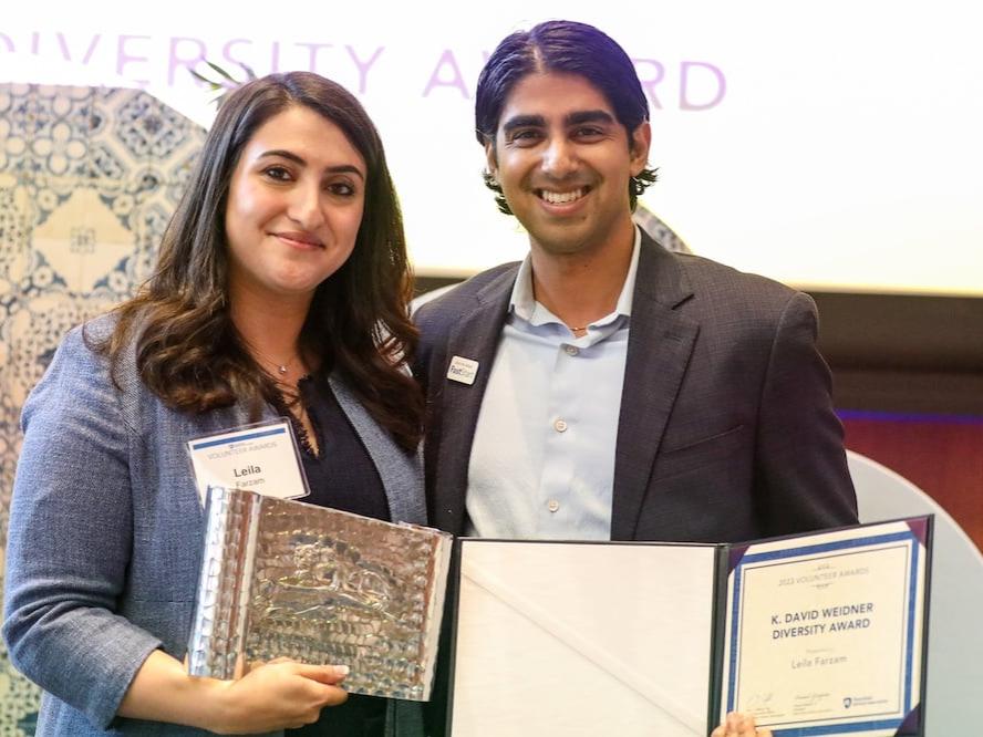 two people receiving and giving an award