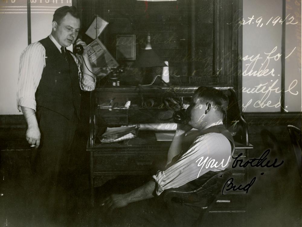 A black-and-white photo from September 9, 1942, shows two men in an office, each on the phone. The man on the left stands with a cigarette, while the man on the right is seated. The background features a cluttered desk. The image includes handwritten text and is signed Your brother, Bud.