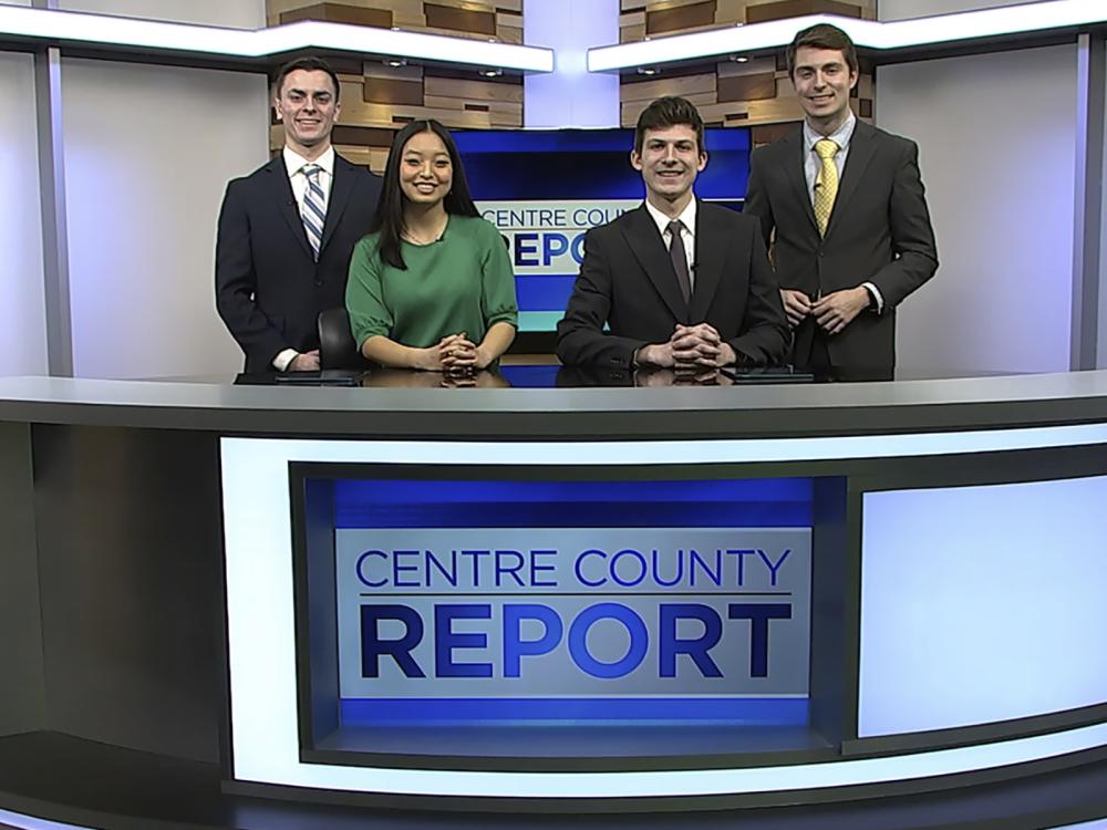 Four students on a TV newscast set