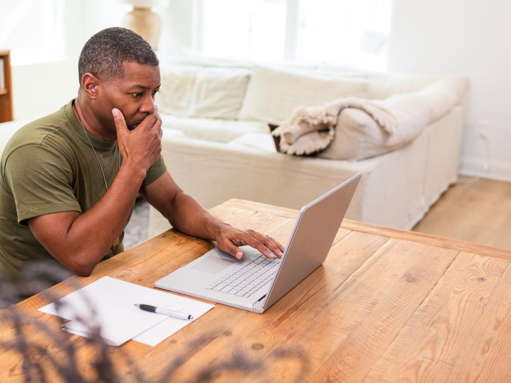 Person sits in front of a laptop