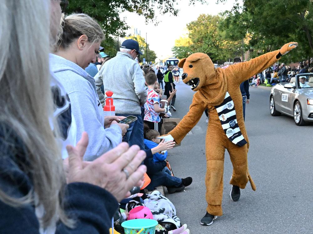 Nittany Lion high-fiving Penn Staters during Homecoming Parade