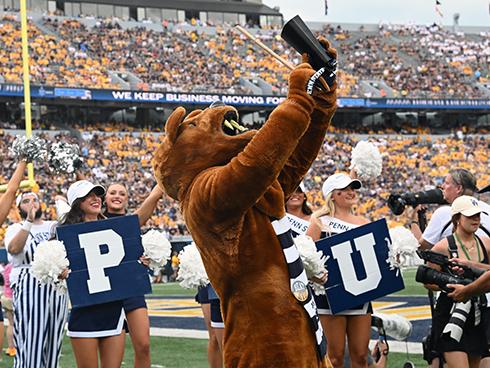 Nittany Lion plays cowbell