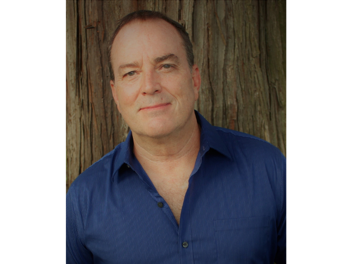 a headshot of a male author 