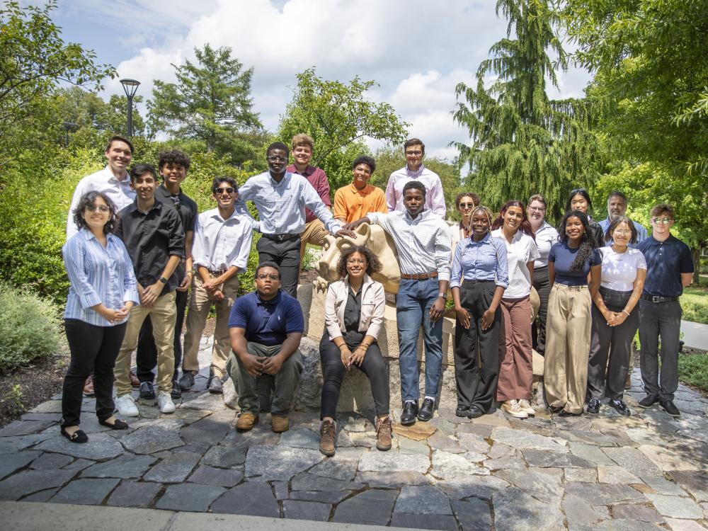 Students in the Engineering Ahead program pose for a photo around the Nittany Lion shrine