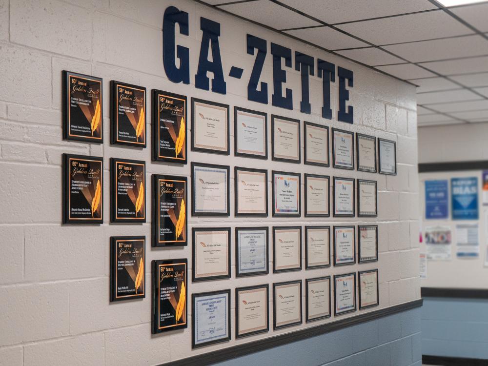 Interior building wall displaying framed awards