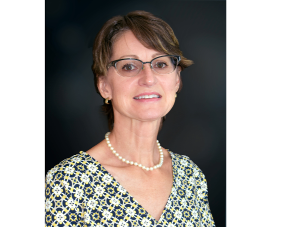 A woman wearing glasses and a necklace