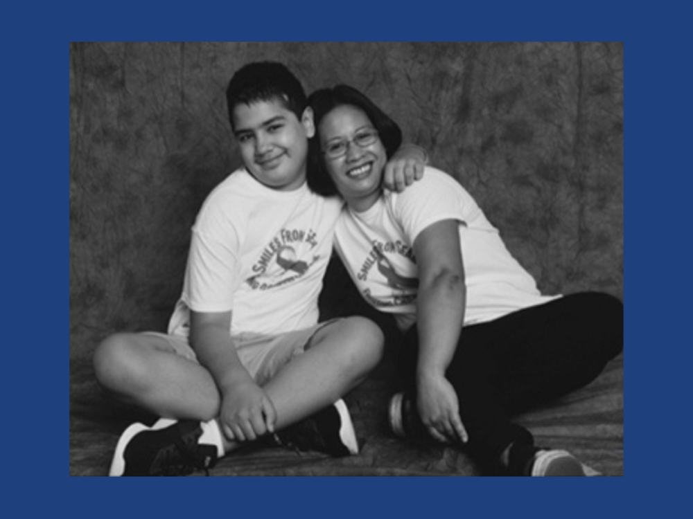 A teen and a woman sit together in a photography studio.