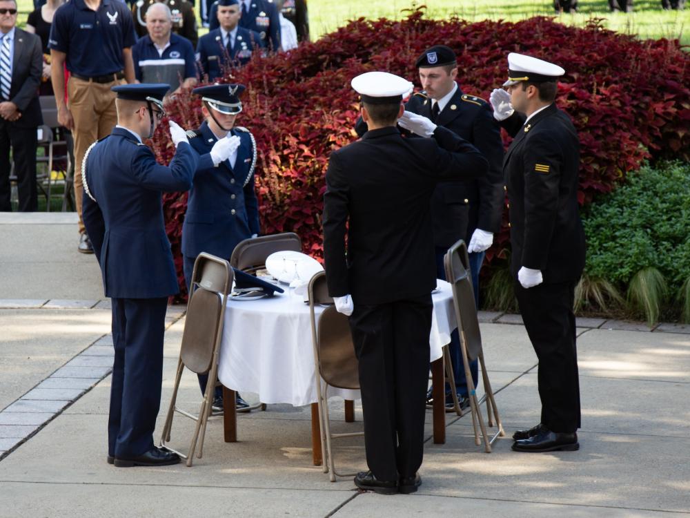 Service members around a missing man table