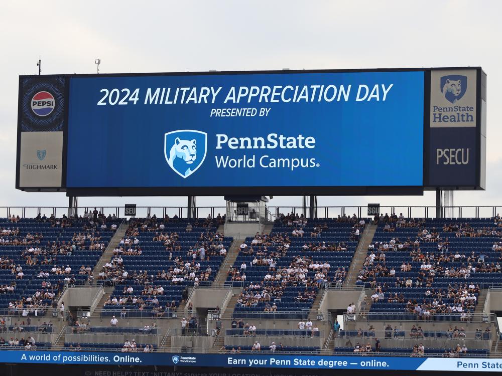 A large digital screen with the Penn State World Campus logo in a stadium.
