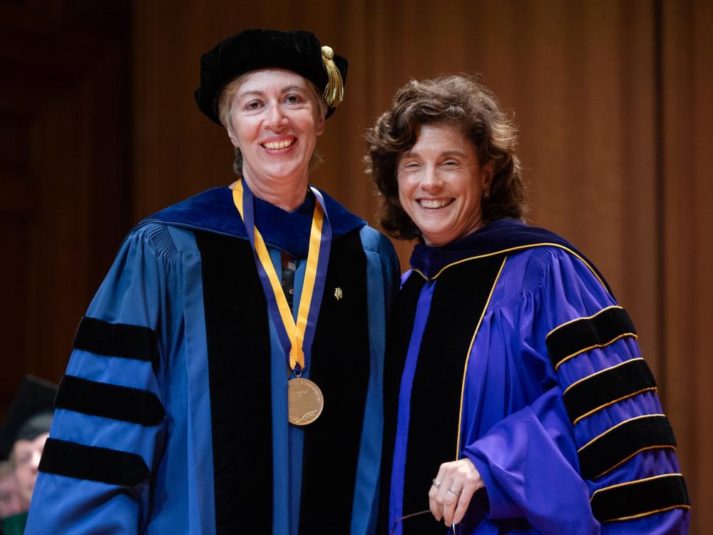 Two women in royal blue academic regalia