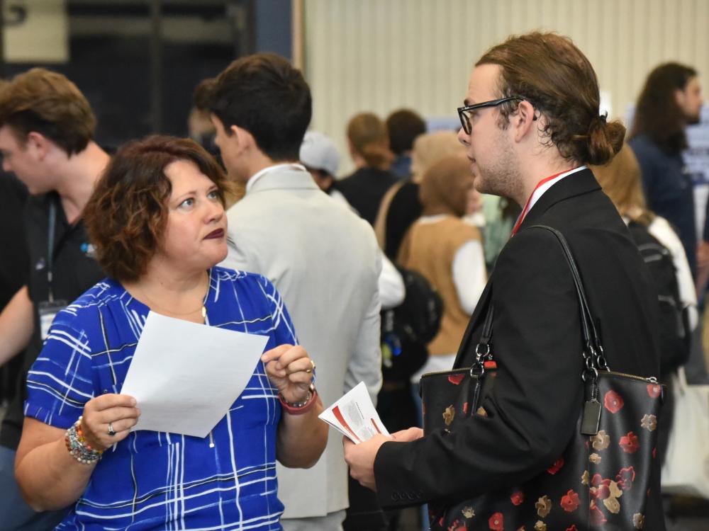 A recruiter talks to a student at Penn State Behrend's fall Career and Internship Fair.