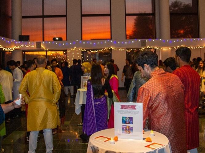 People gather at an event wearing Indian attire