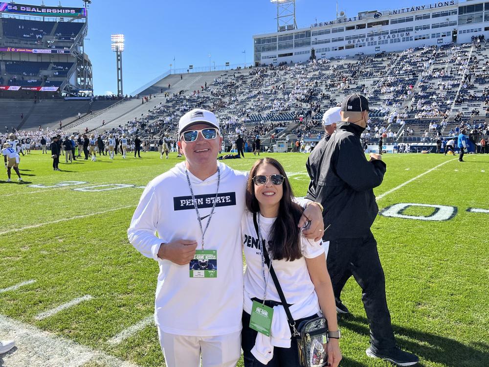 A photo of Dan and Robyn Ives on the sideline at Beaver Stadium.