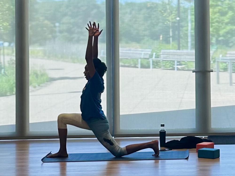 Yoga instructor Latisha Franklin leads a stretch at the Palmer Museum of Art