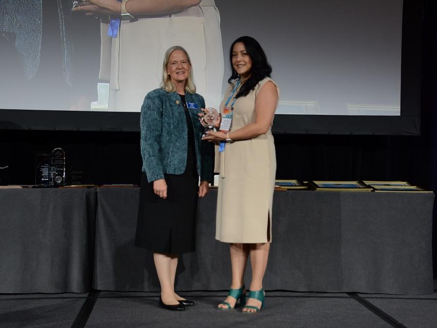 Juliana Vasco-Correa, right, receives an award