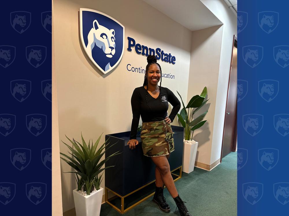 Woman standing in front of Penn State sign