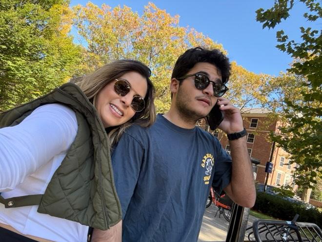 A mother and son smile while exploring campus