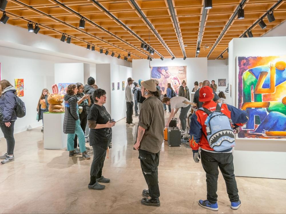 People talking and looking at art in a gallery