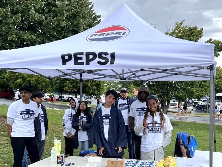 A group of students at a football game tailgate event.