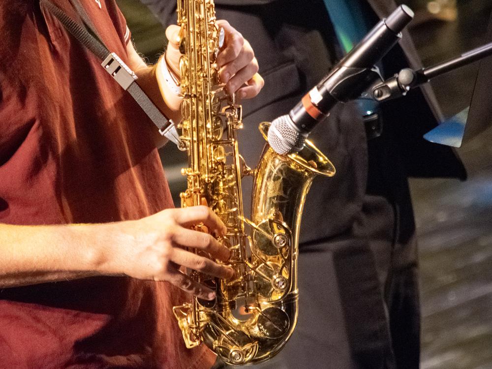 Closeup of a person playing a saxophone