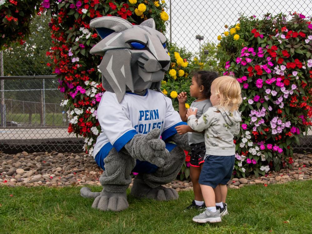 The Penn College Wildcat mascot greets children at the Children's Learning Center