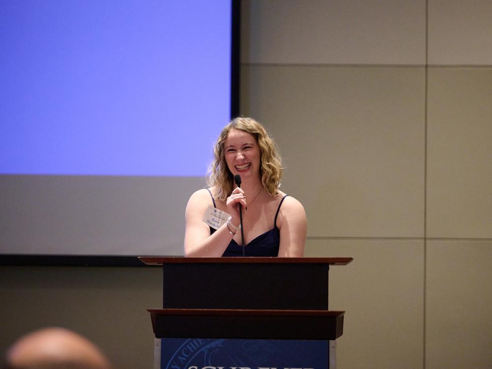 Katherine Marakovits standing at a podium