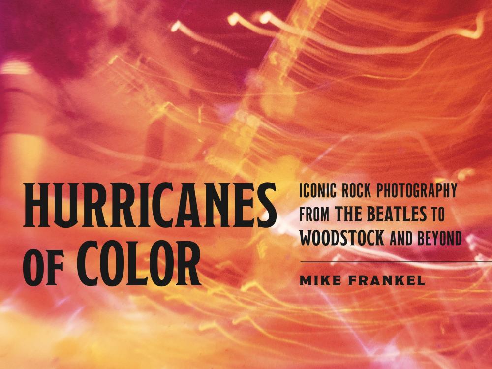 Book cover of Hurricanes of Color by Mike Frankel. The book title, subtitle, and author are in black text. The cover image is a pink, orange, and yellow photo of a musician. It is a bit blurry, giving it a psychedelic quality.