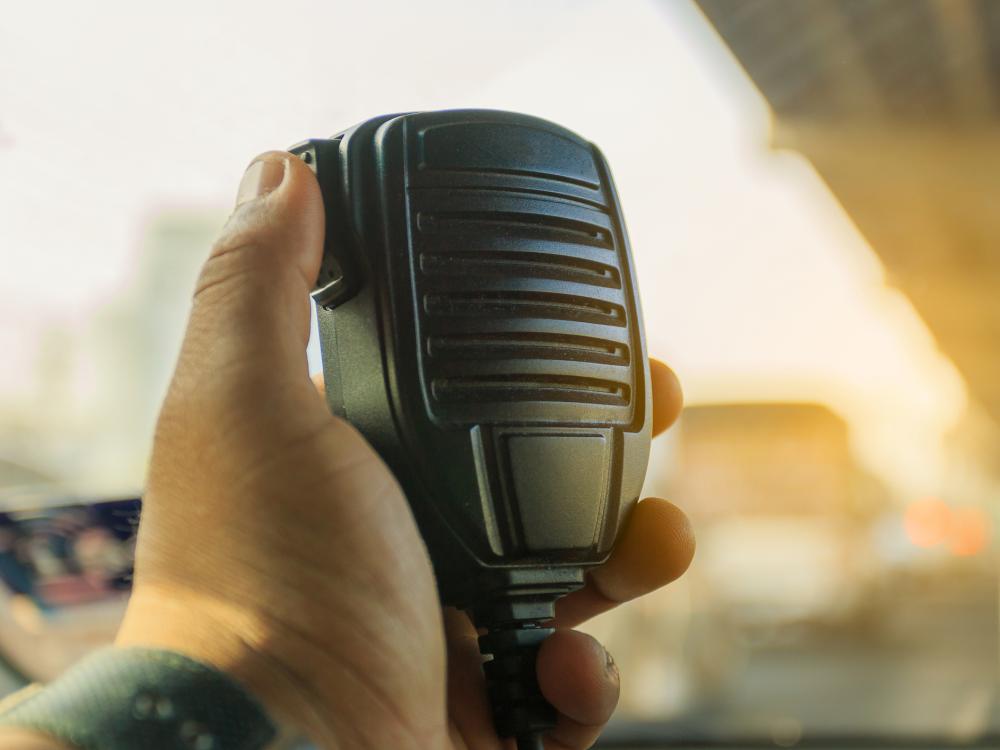 A hand holding a radio handset