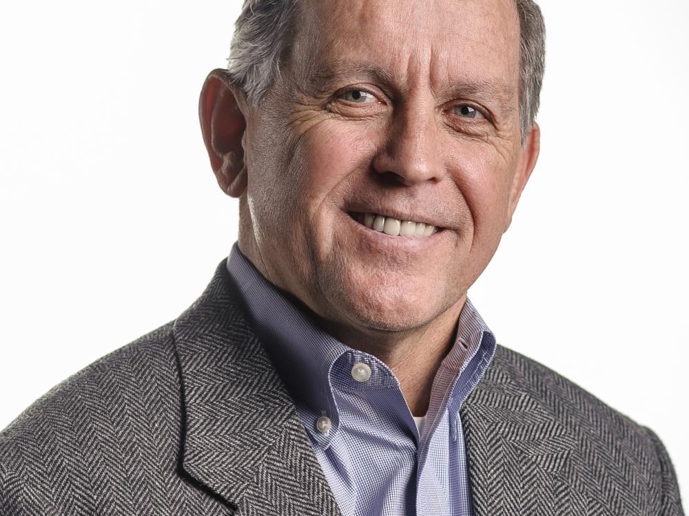 a headshot of a man in a suit jacket